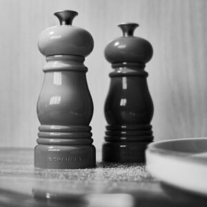 a couple of black and white chess pieces on a table